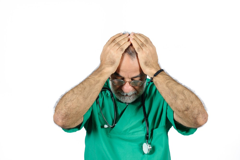 doctor grieving with head down