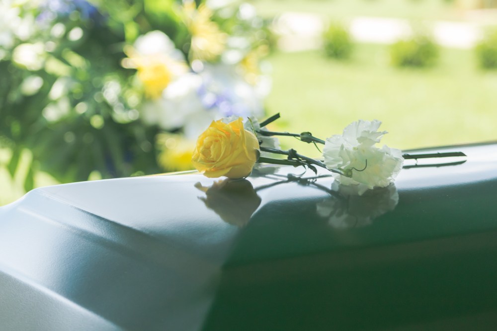 Flowers resting on a casket.