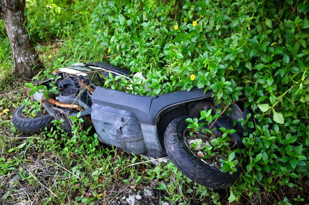 wrecked motorcycle lying in the grass