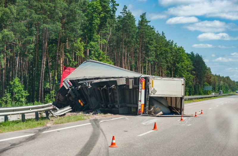truck smashes into the guardrail and rolls over