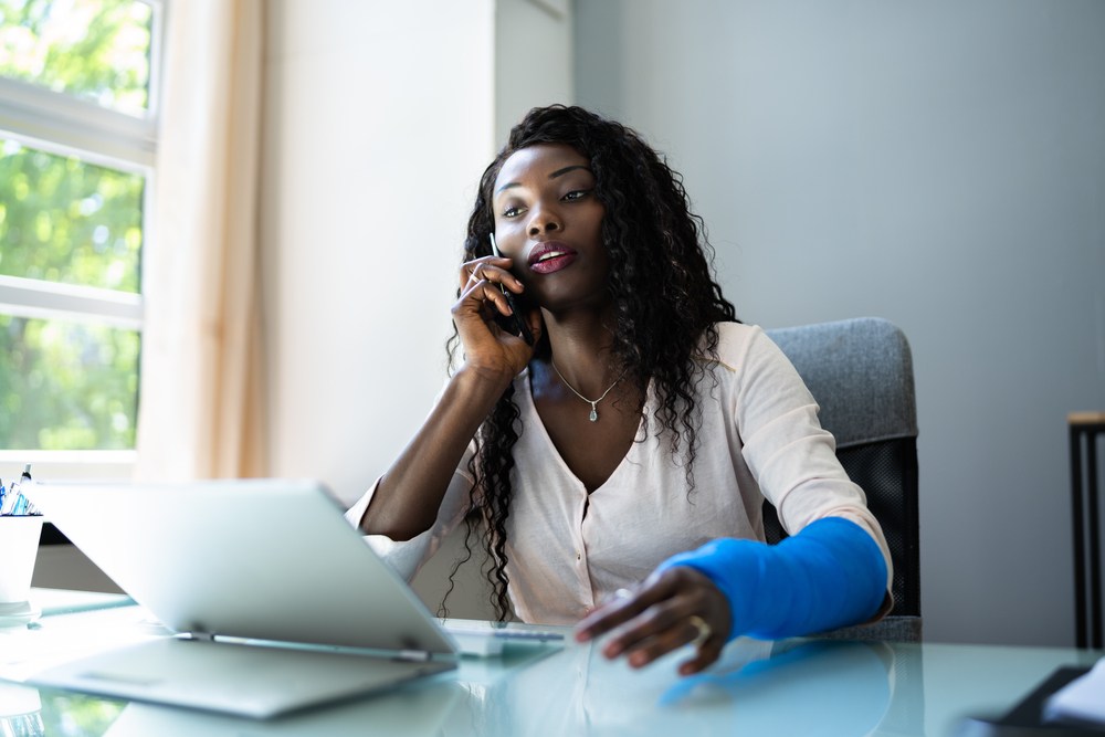 black woman on the phone with worker’s comp