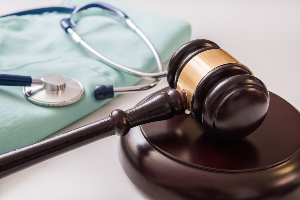 gavel next to nurse’s scrubs