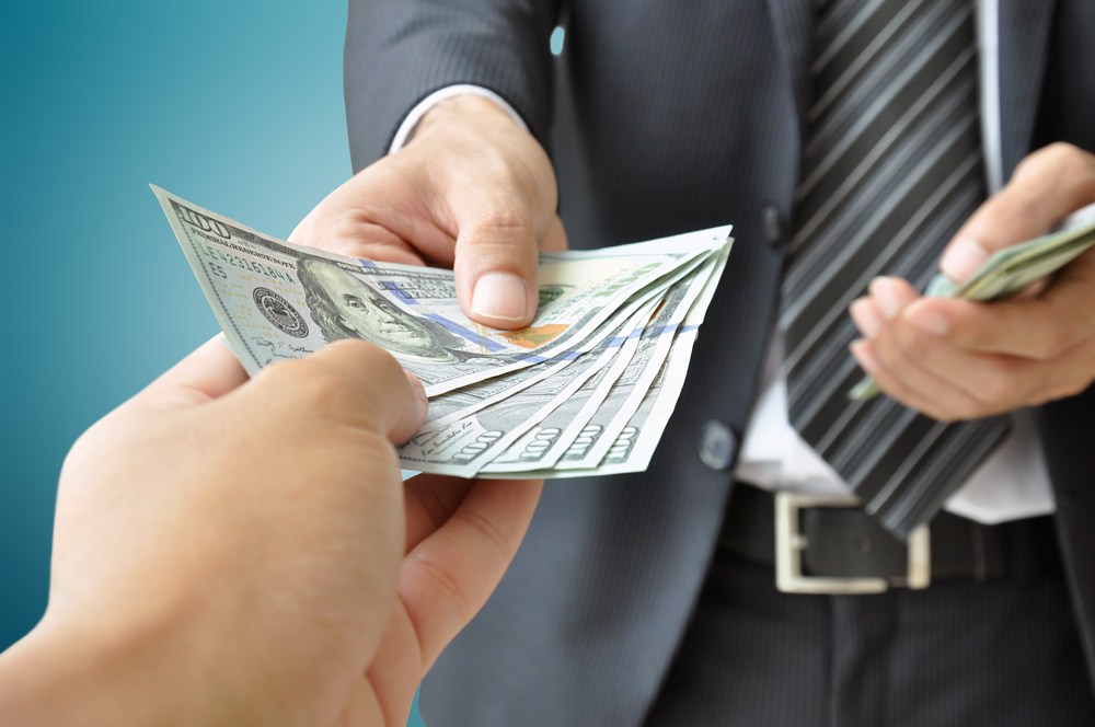 lawyer handing over a cash payout