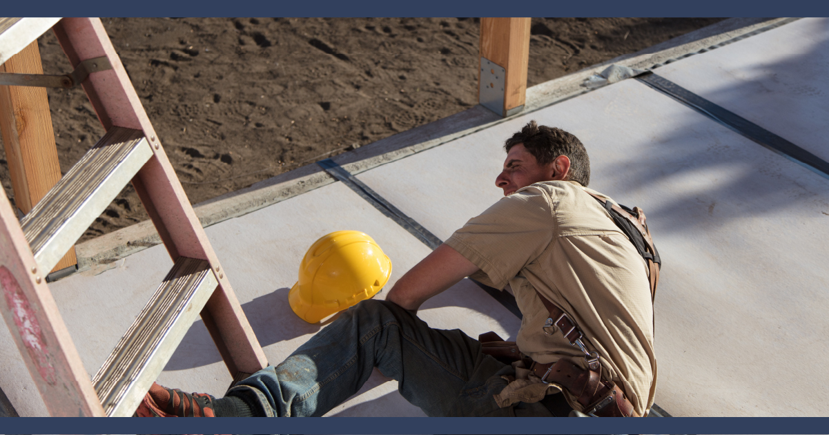 Construction worker on ground, having fallen off a ladder