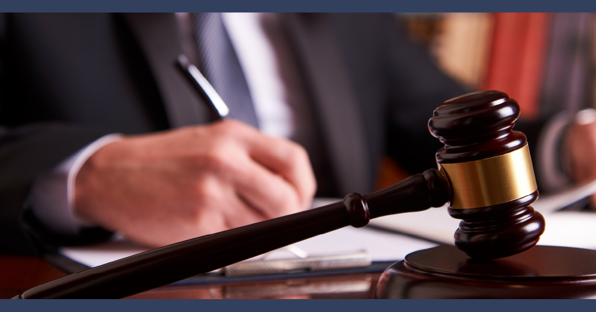 Close up of lawyer using a pen to sign a document.
