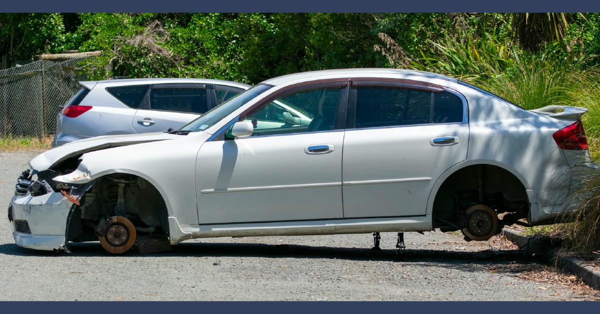 Silver car without wheels, totaled and unbale to be driven