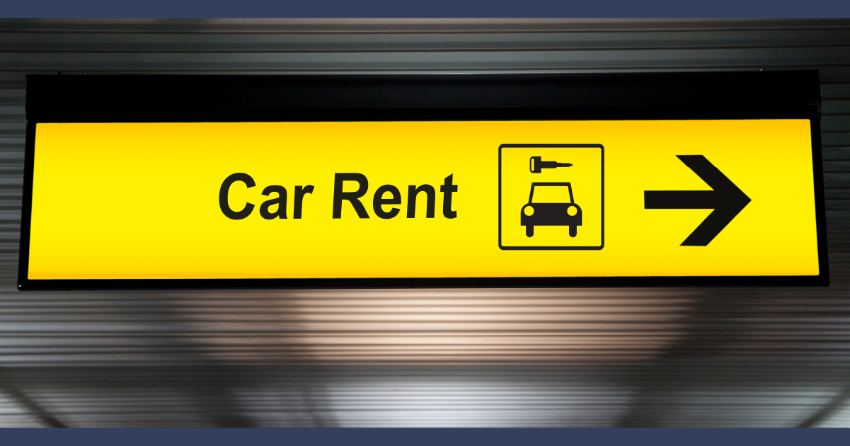 illuminated yellow sign reading 'Car Rent' and an arrow on it