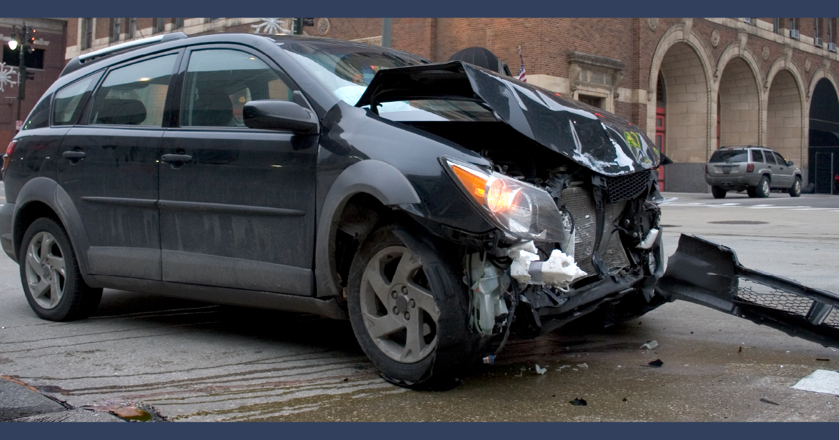 grey car with damage to the hood and front bumper