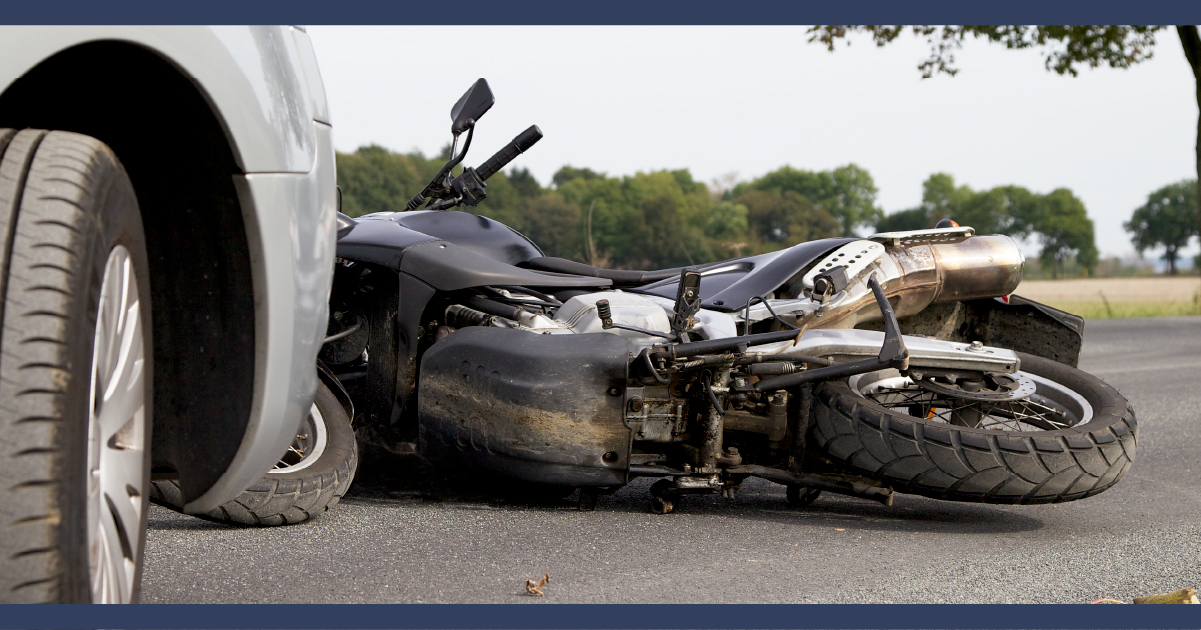 Motorcycle crushed under car