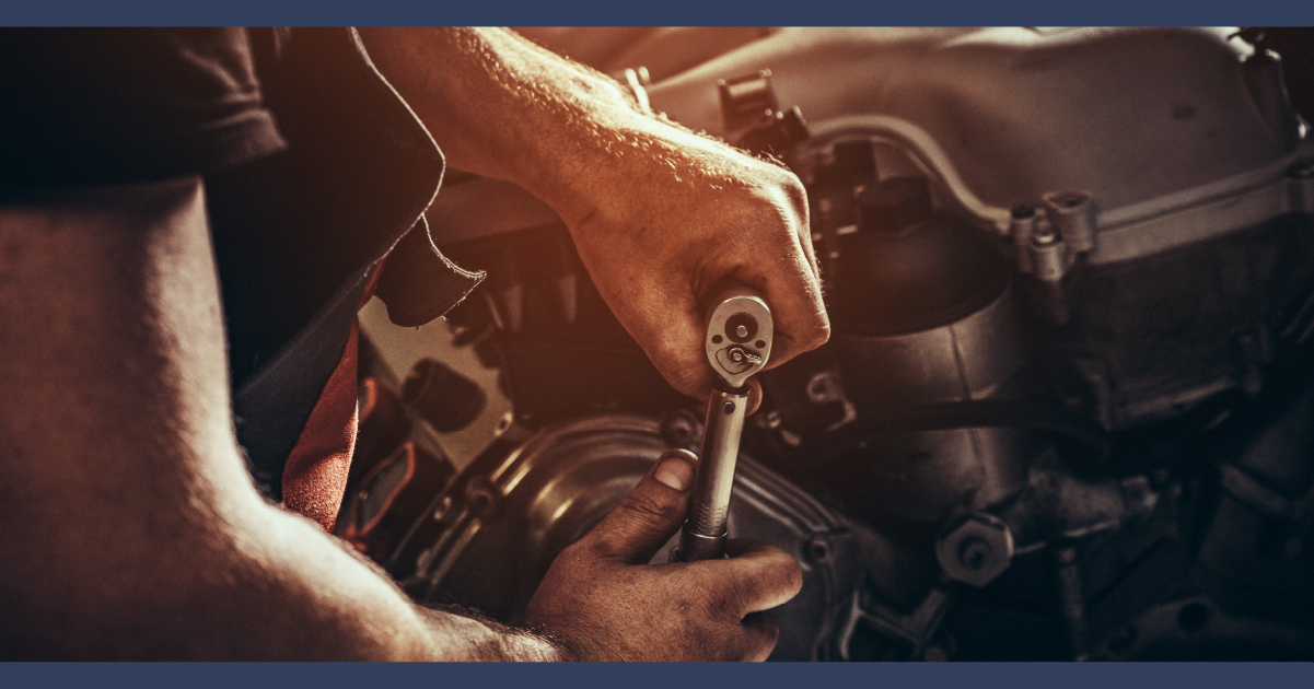 Close up of hands working on motorcycle engine