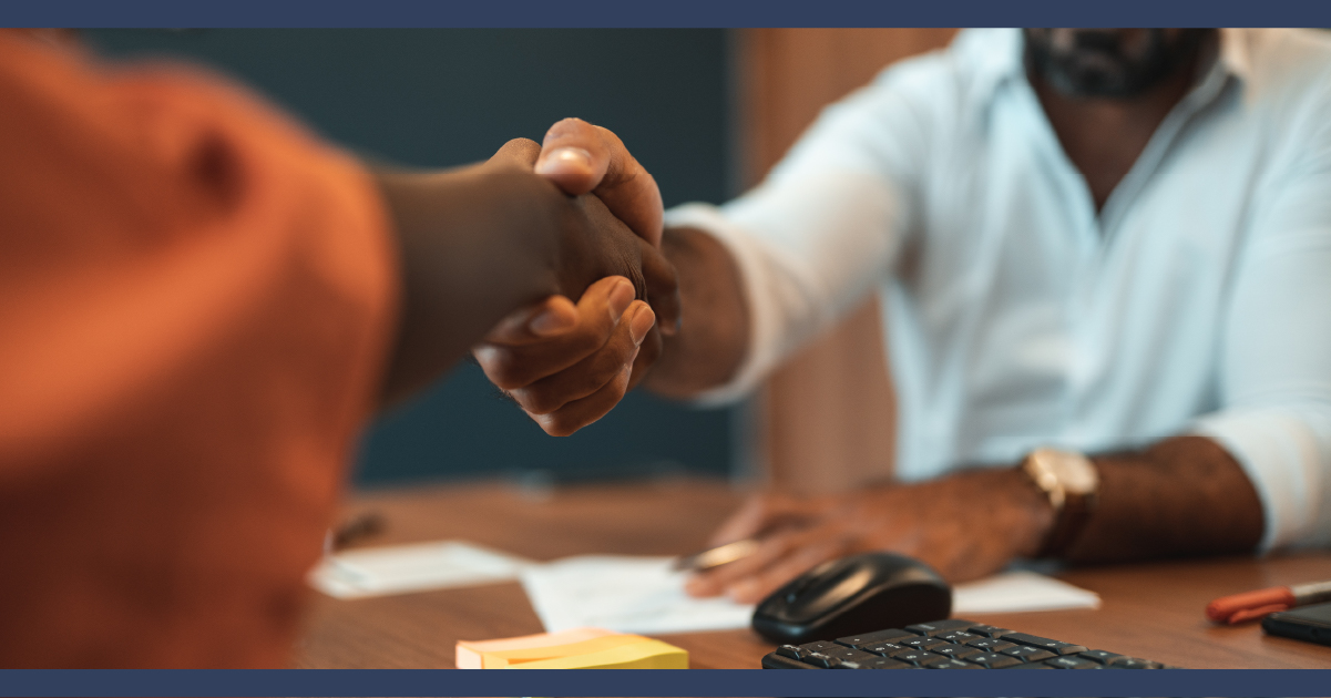 Man and woman shaking hands over a lawyer's desk