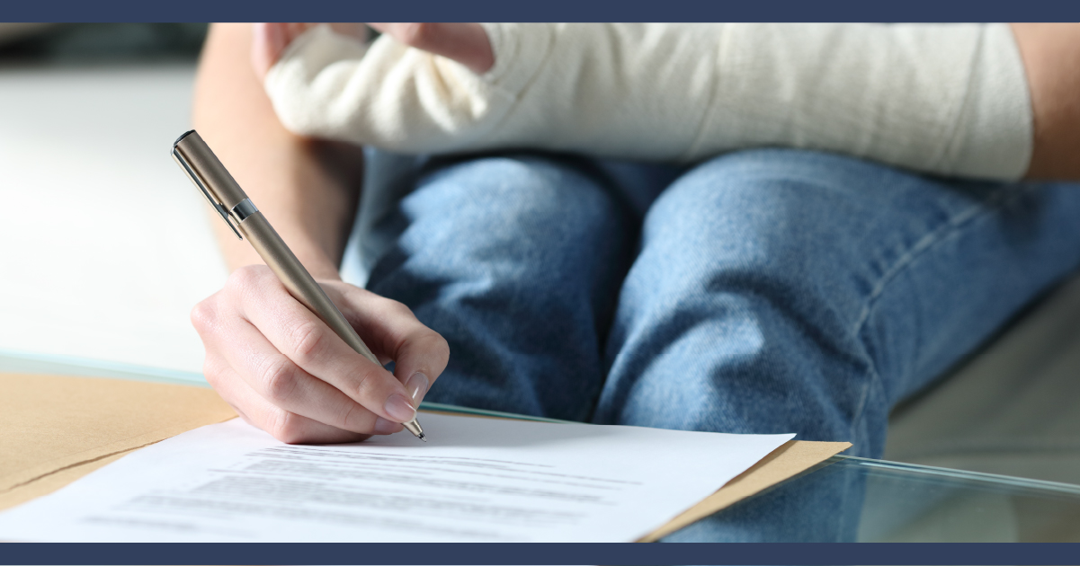 person with arm in cast signing legal looking paperwork