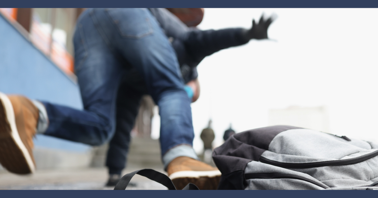 rear view of person mid-falling in the street