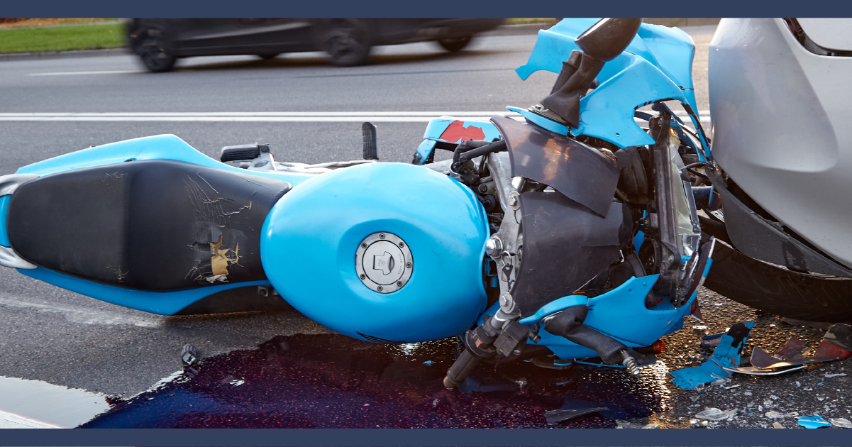 Blue motorcycle wreck lying on the road
