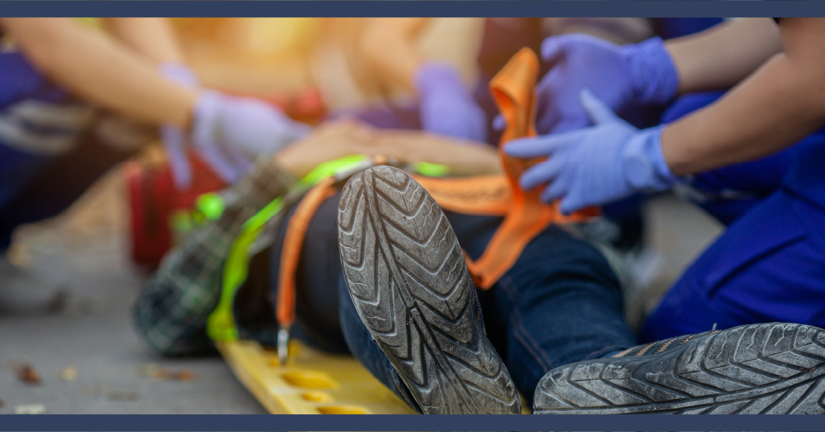 Close up of a person on a medical stretcher with paramedic working to help them