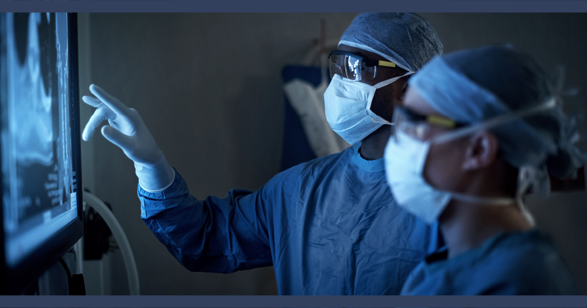 Doctors in medical gowns looking at an x-ray