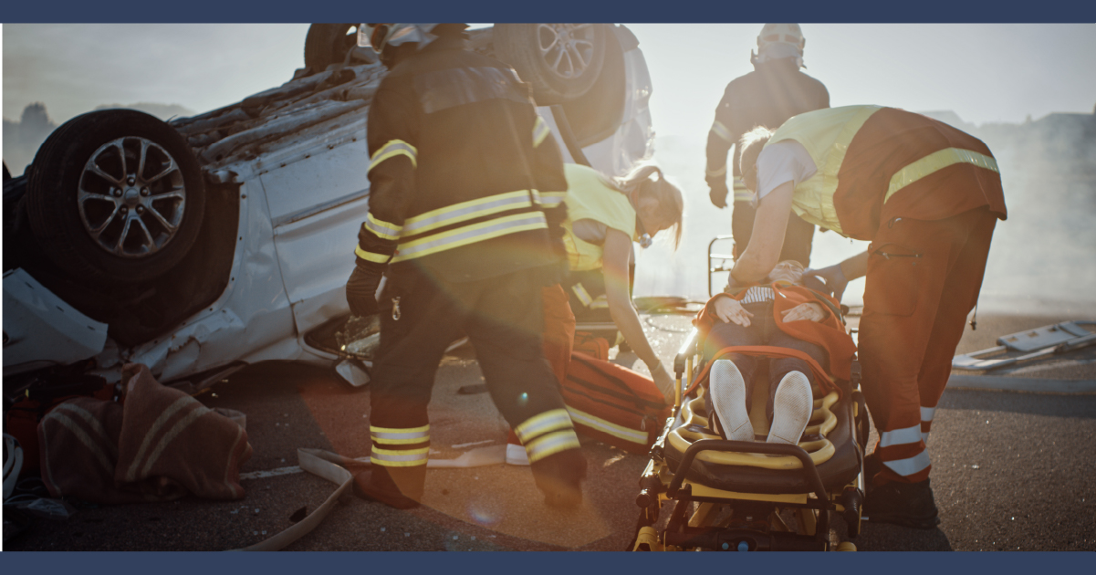 Fight fighters near a crashed car rescuing a patient.