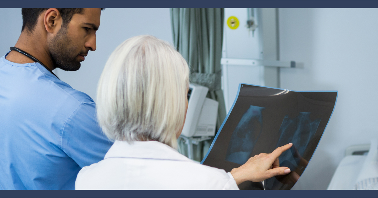 Two medical personnel looking at an X-ray