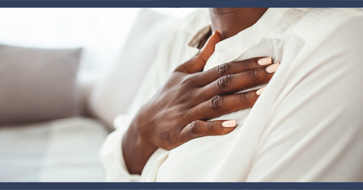 Woman clutching her chest in pain or distress