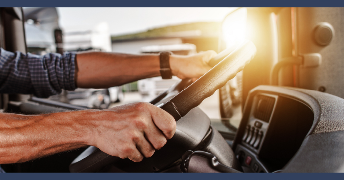 Close up of bus driver hands on steering wheel of bus