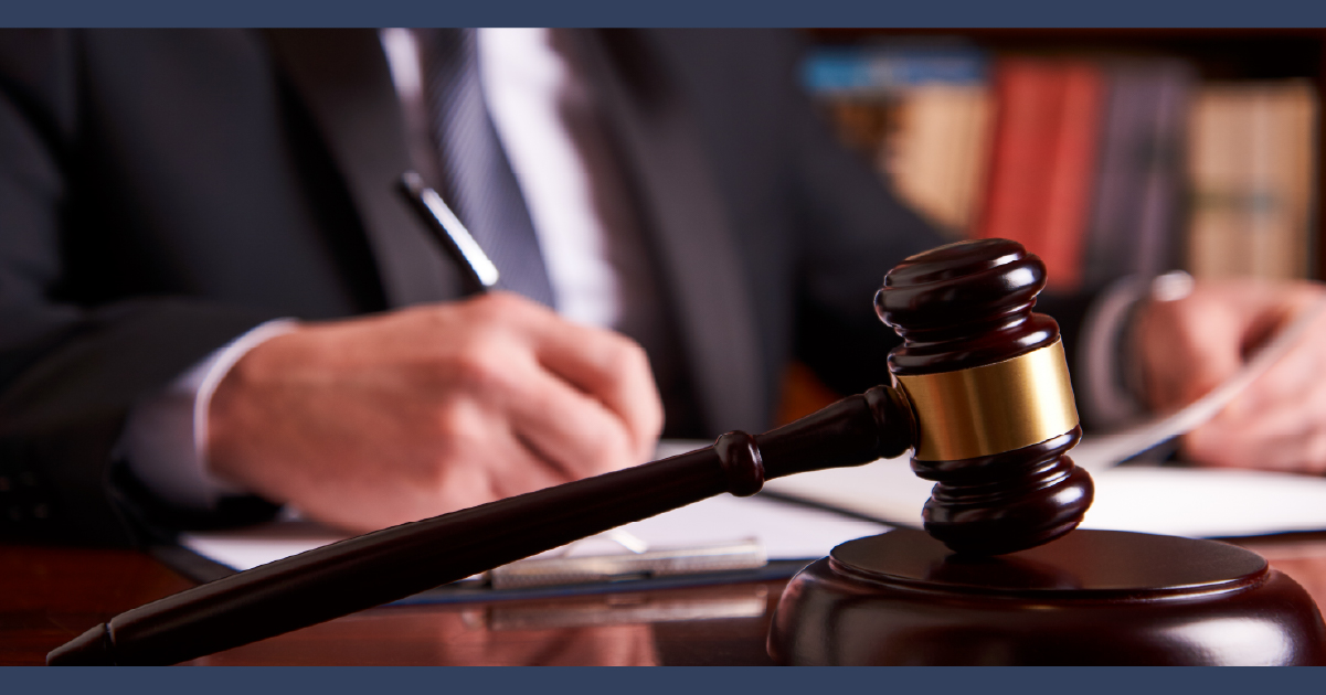 Man in suit signing legal paperwork