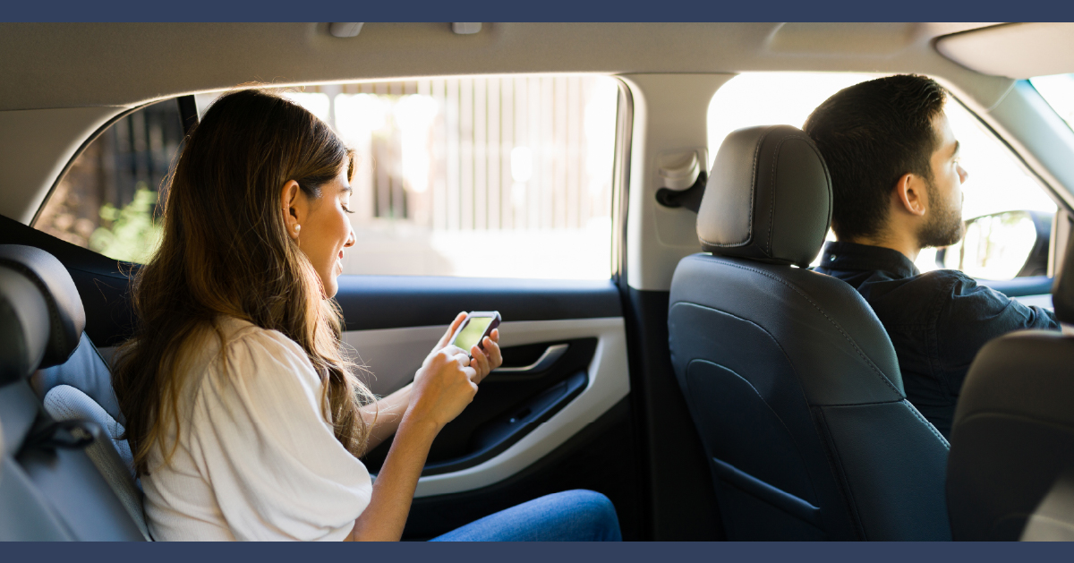 A woman in the back of a rideshare car