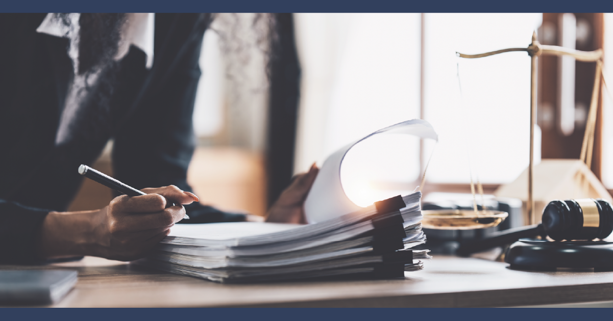 Lawyer with paperwork shacked on their desk